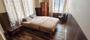 a small bedroom with a bed and a window at Dreamstay lodge in Kohīma