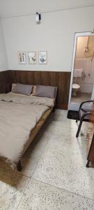 a bed in a room with a mirror and a chair at Dreamstay lodge in Kohīma
