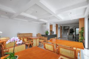 a dining room with wooden tables and chairs at Jun hade on hillside in Hangzhou