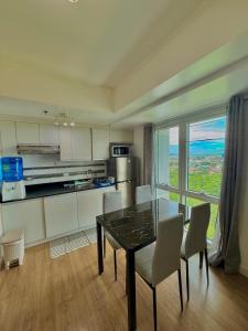 a kitchen with a table and chairs in a room at trendy & Reliable Condo unit in Davao City