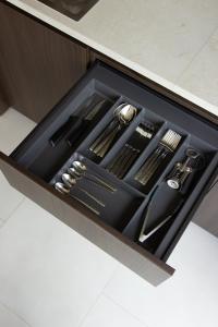 a drawer filled with utensils in a cabinet at Vershky Villas Верховина in Verkhovyna