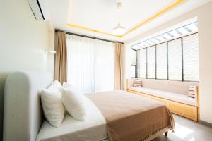 a bedroom with a bed and a large window at Villa Palma 2 in Beyobası +34 photos