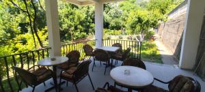 a patio with tables and chairs on a balcony at Apartmani Vučević in Sutomore