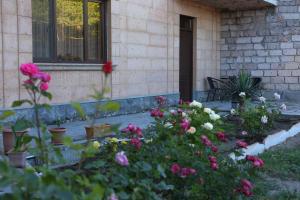 a garden of flowers in front of a house at Airport Garden hotel in Pʼarakʼar