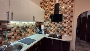 a kitchen with a sink and a counter top at See4YOU in Odesa