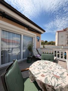 a patio with a table and chairs on a balcony at Apartments Ostojic in Krk
