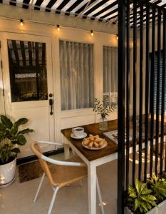 a table and chair with a plate of food on it at บ้านเคียงคลื่น in Cha Am