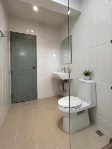 a bathroom with a toilet and a sink at บ้านเคียงคลื่น in Cha Am +16 photos