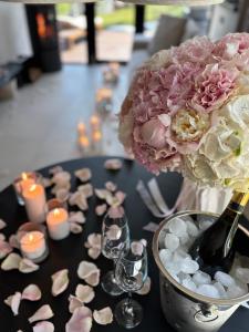 a table topped with a vase with flowers and candles at Vershky Villas Верховина in Verkhovyna