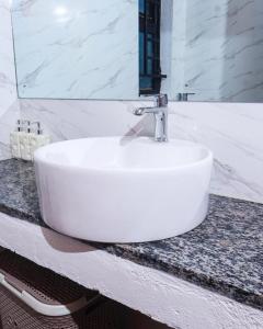 a white sink on a counter in a bathroom at Torriam Apartments in Chongwe +59 photos