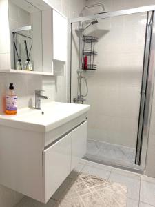 a white bathroom with a sink and a shower at King Suite SS18 in Istanbul +14 photos