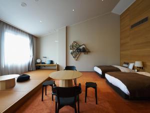 a hotel room with a bed and a table and chairs at A village in Fujikawaguchiko +97 photos