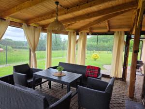 a patio with a table and chairs and a view at Agroturystyka u Kasi in Suryty
