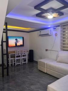 a living room with a couch and a table at Su Staycation Minimalist in Naic