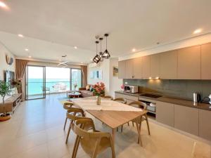 a kitchen and dining room with a table and chairs at Căn hộ The Song Du lịch biển Tháp Tam Thắng INFINITY POOL FREE IN SIDE THE SEA in Vung Tau