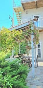 a pergola with tables and chairs in a yard at Villa Klavia in Zatoka +22 photos