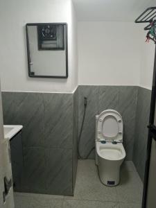 a bathroom with a toilet and a picture on the wall at Su Staycation Minimalist in Naic +7 photos