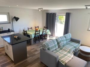 a living room with a couch and a table at Bell air Max in Les Hauts-Geneveys