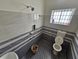 a bathroom with a toilet and a sink at Jorhat Homestay in Jorhat