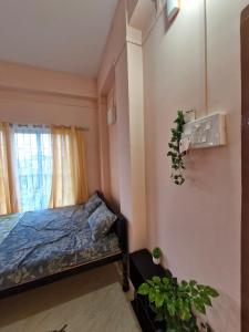 a bedroom with a bed and a window at Jorhat Homestay in Jorhat