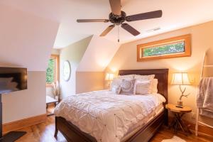 a bedroom with a bed and a ceiling fan at Headwaters Hideaway in Elk Park
