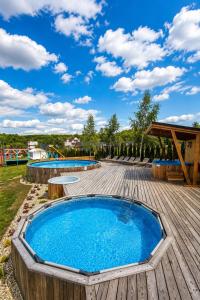 a pool on a wooden deck with two swimming pools at Agro Solina in Solina