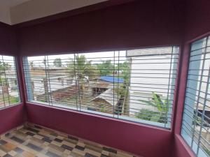 a room with three windows with blinds on them at Jorhat Homestay in Jorhat +17 photos