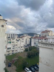 a view of a city with parked cars and buildings at Marina Luka in Bar