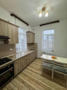 a large kitchen with wooden cabinets and a counter top at Narek Home Goris in Harzhis