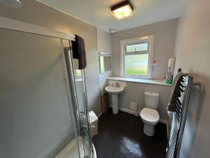 a small bathroom with a toilet and a sink at The Bunkhouse in Applecross +12 photos