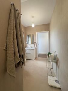 a bathroom with a sink and a towel on the wall at Apartament Spokojny in Łańcut +8 photos