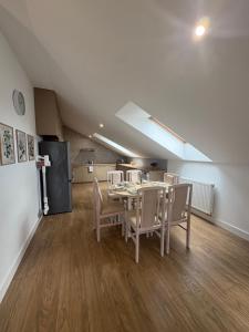 a dining room with a table and chairs and a refrigerator at Apartament Spokojny in Łańcut