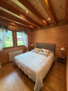 a bedroom with a bed in a wooden cabin at Chalet Pétérets in Samoëns