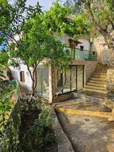 a staircase leading to a house with a tree at Mount Kalathi Seaview Retreat in Verga Kalamata