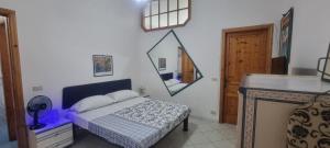 a bedroom with a bed and a mirror on the wall at Abbronzatissima Capo d'Orlando in Capo dʼOrlando +48 photos