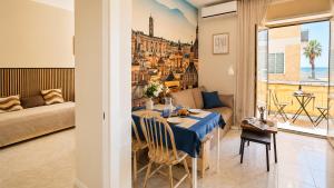 a dining room with a table and a view of a city at Oceanine 7 - Seaview Apartment in Lido di Ostia