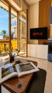 a table with a book on it in a living room at Oceanine 7 - Seaview Apartment in Lido di Ostia