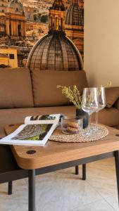 a coffee table with a book and wine glasses on it at Oceanine 7 - Seaview Apartment in Lido di Ostia +19 photos