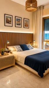 a bedroom with a large bed and two tables at Oceanine 7 - Seaview Apartment in Lido di Ostia