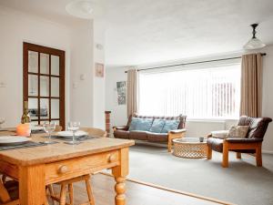 a living room with a table and a couch at Pine Hill Lodge in Guisborough +9 photos