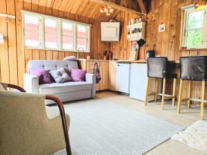 a living room with a couch and a kitchen at Stevns Birkevang The Silo - Rural refuge in Faxe