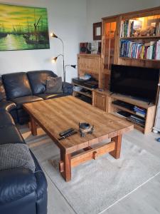 a living room with a wooden coffee table at Fjordhytte-24 in Bøvågen