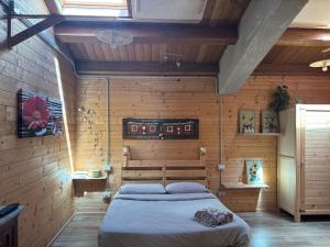 a bedroom with a bed in a wooden room at Le scalette di Giocondo in Roio Piano