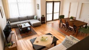 a living room with a couch and a table at Spacious Villa with Sea and Mountain View in Kemer