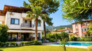 a villa with a swimming pool in a resort at Spacious Villa with Sea and Mountain View in Kemer