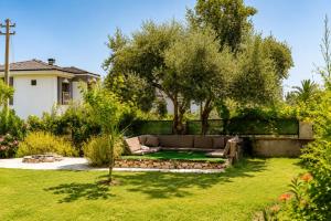 a garden with a couch in the middle of a yard at Spacious Villa with Sea and Mountain View in Kemer