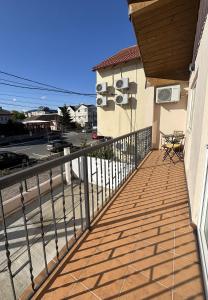 a balcony of a house with a wooden deck at Casa Silvia in Costinesti