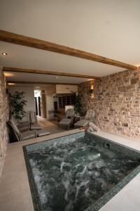 a large swimming pool in a room with a stone wall at South Causey Inn in Stanley