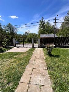 a walkway in a yard with a fence at Vlădești house in Vlădeşti