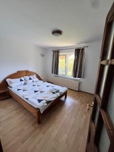 a bedroom with a bed in a room with a window at Vlădești house in Vlădeşti